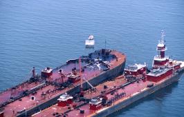 Oil-soaked barge surrounded by oil-containing booms (Tampa Bay) NOAA