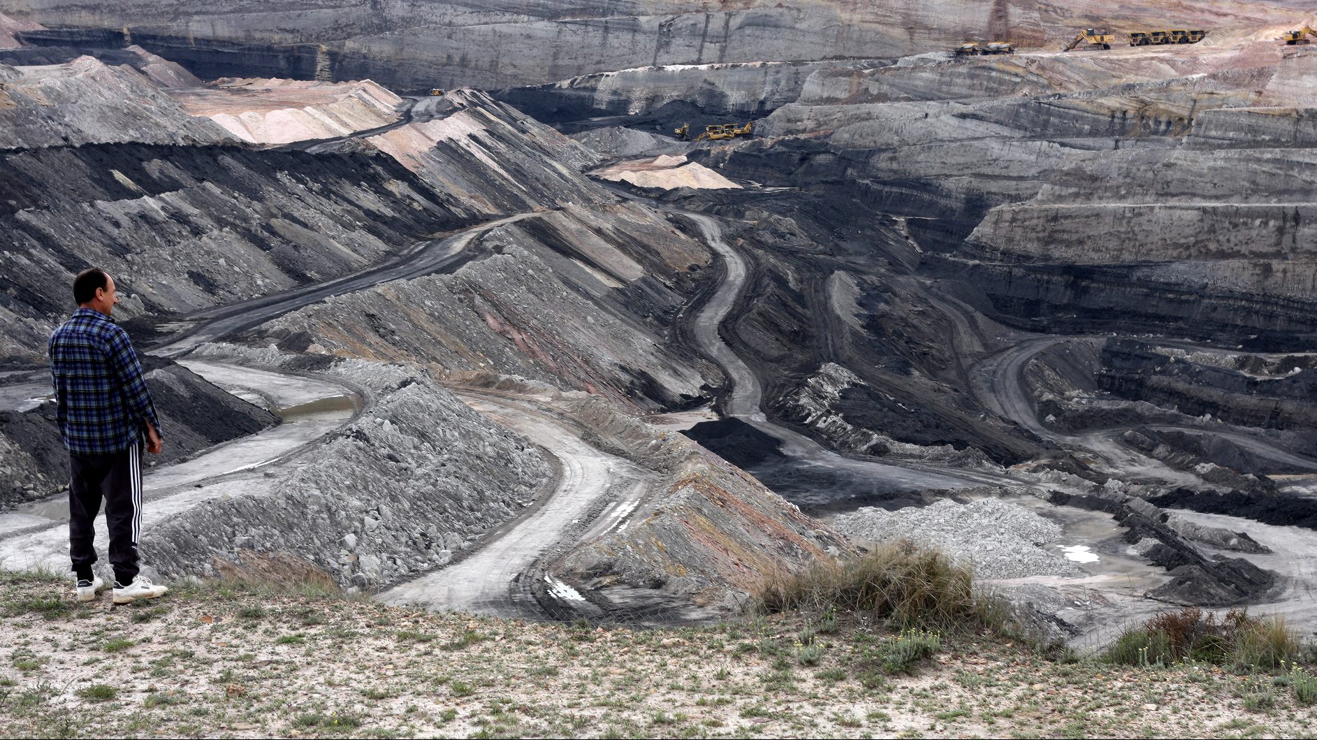 Man stares at strip mined landscape