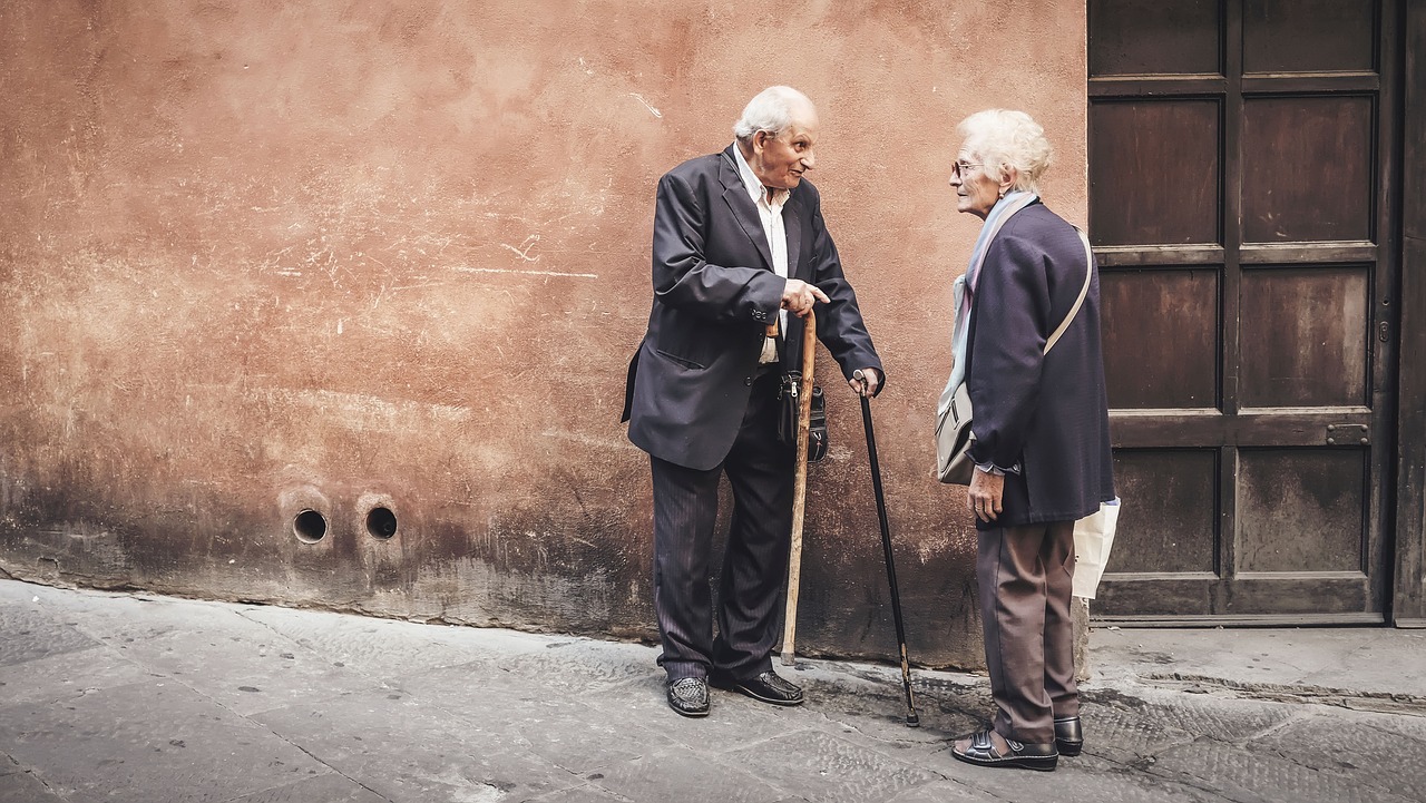 Elderly man and woman in lively discussion