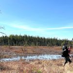 Peat landscape and sky with figure walking
