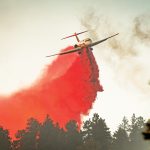 Plane dumping fire retardant